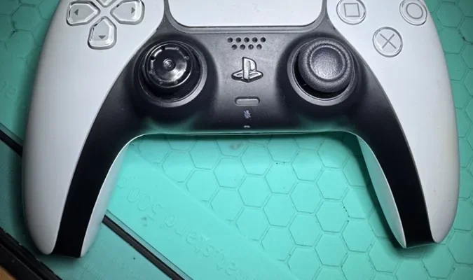 Mando PS5 DualSense con joystick desgastado, antes de la reparación